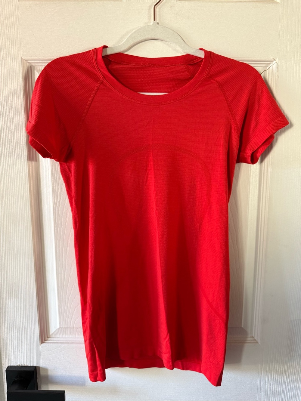 Red lululemon Swiftly Tech short-sleeve shirt, size 6, in the hip-length style